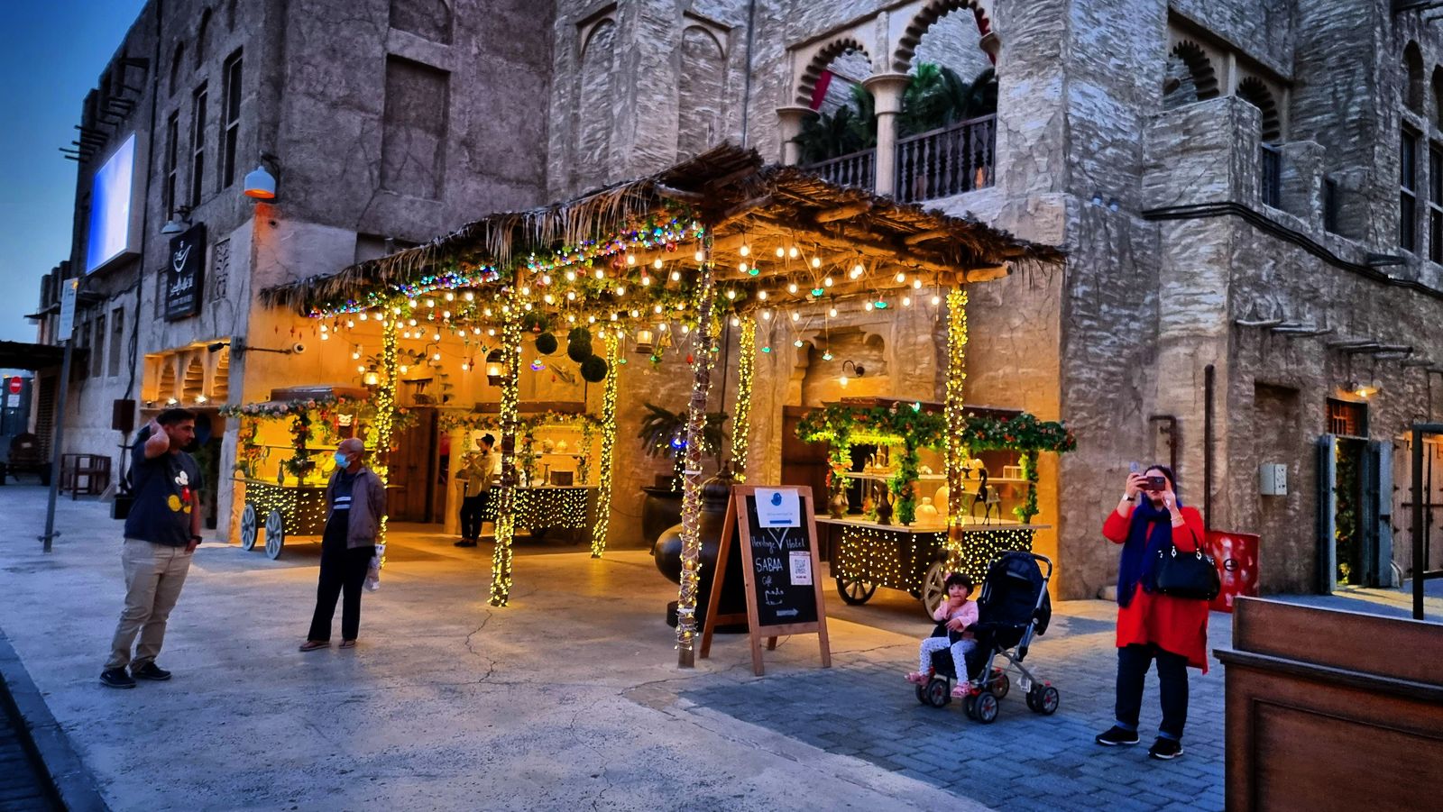 Al Seef heritage souk street strung with fairy lights at dusk